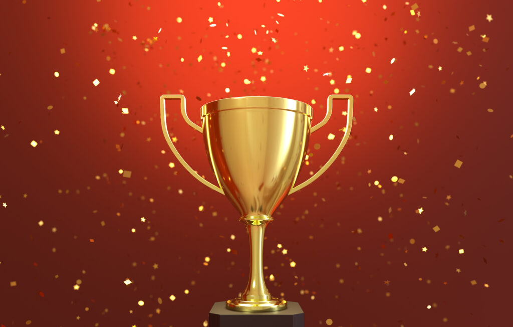 golden-trophy-with-falling-golden-confetti-1024x652.jpg