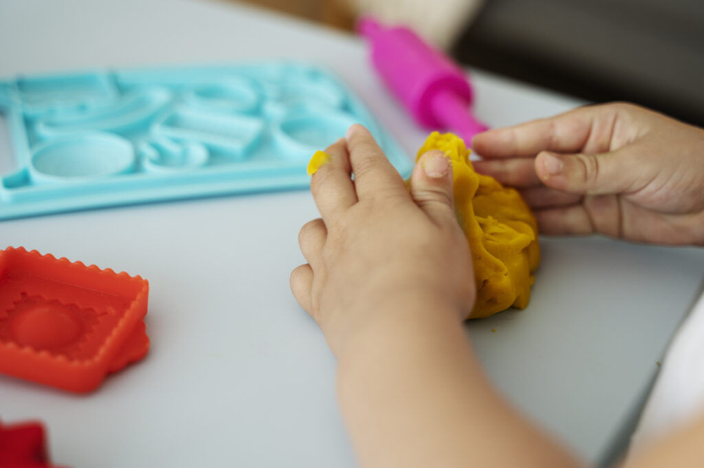 side-view-kid-playing-with-playdough-1024x681.jpg